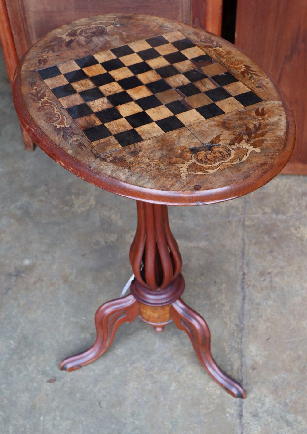 A Victorian inlaid walnut oval tripod games table, width 60cm depth 41cm height 71cm